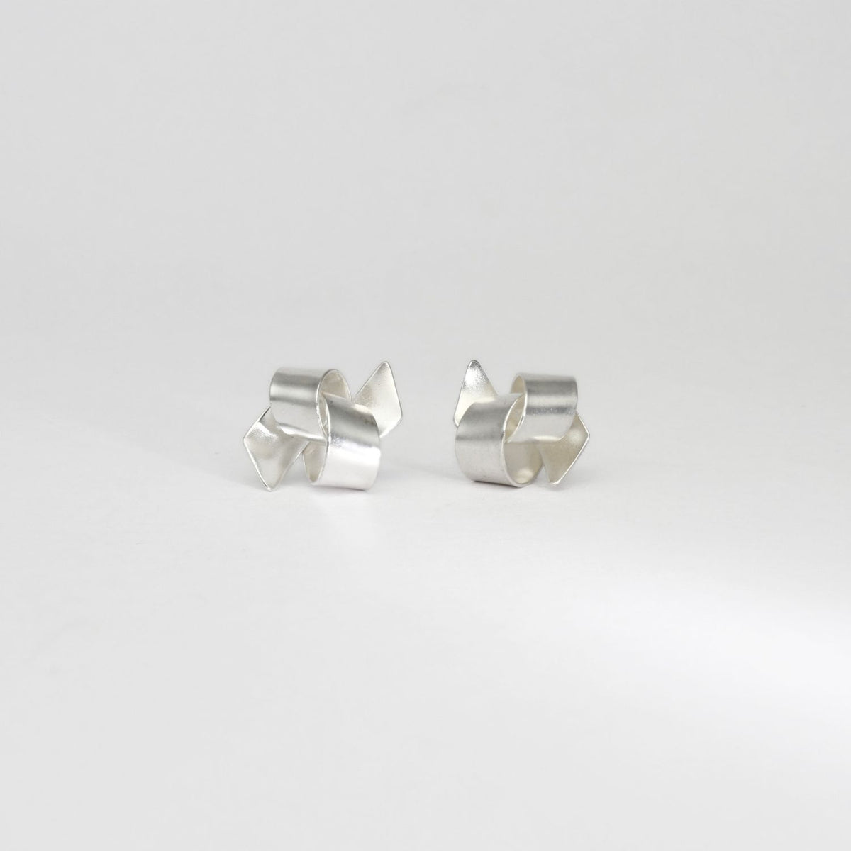 Ribbon knot tied silver stud earrings by Jodie Hook