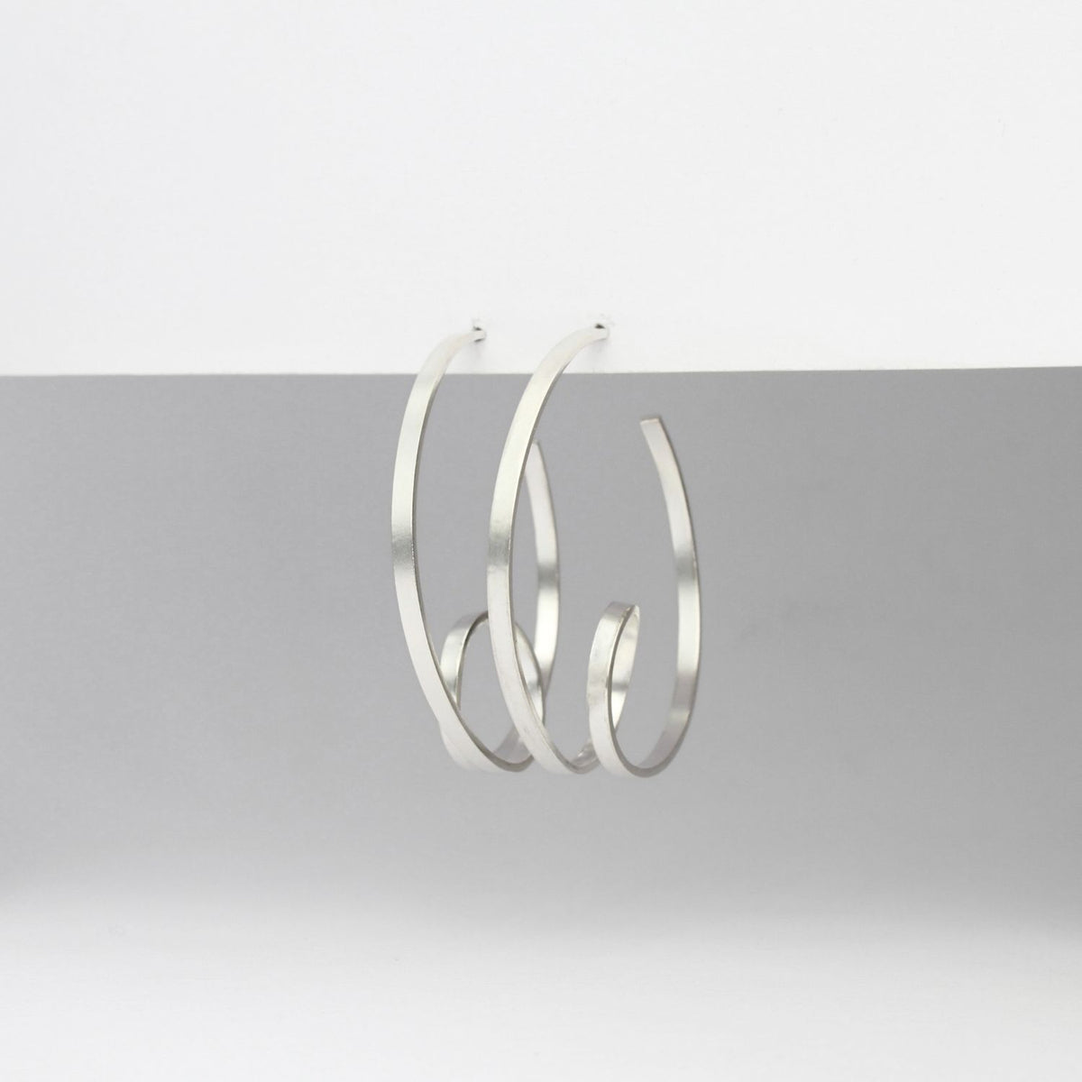 Ribbon loop silver hoop earrings by Jodie Hook