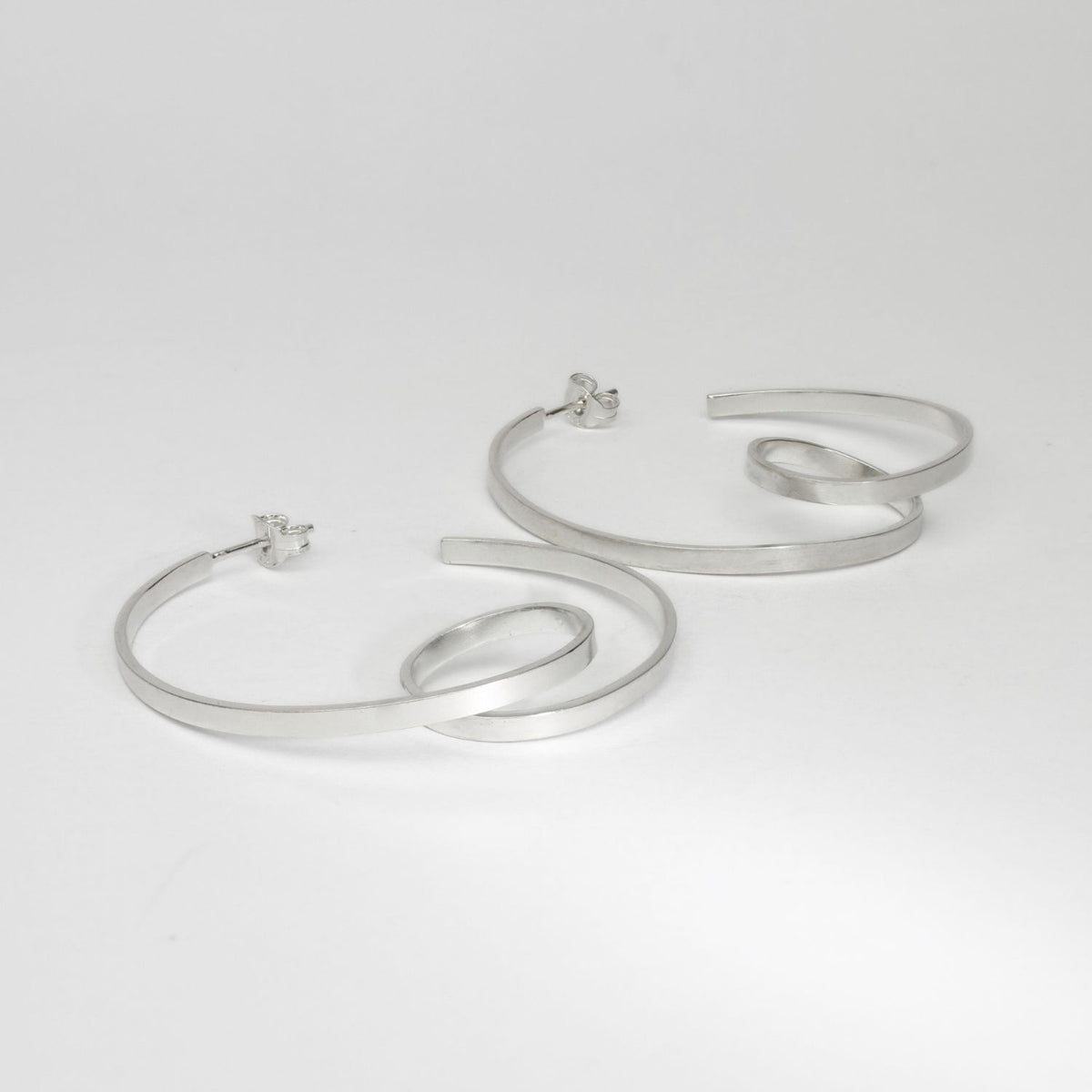 Ribbon loop silver hoop earrings by Jodie Hook