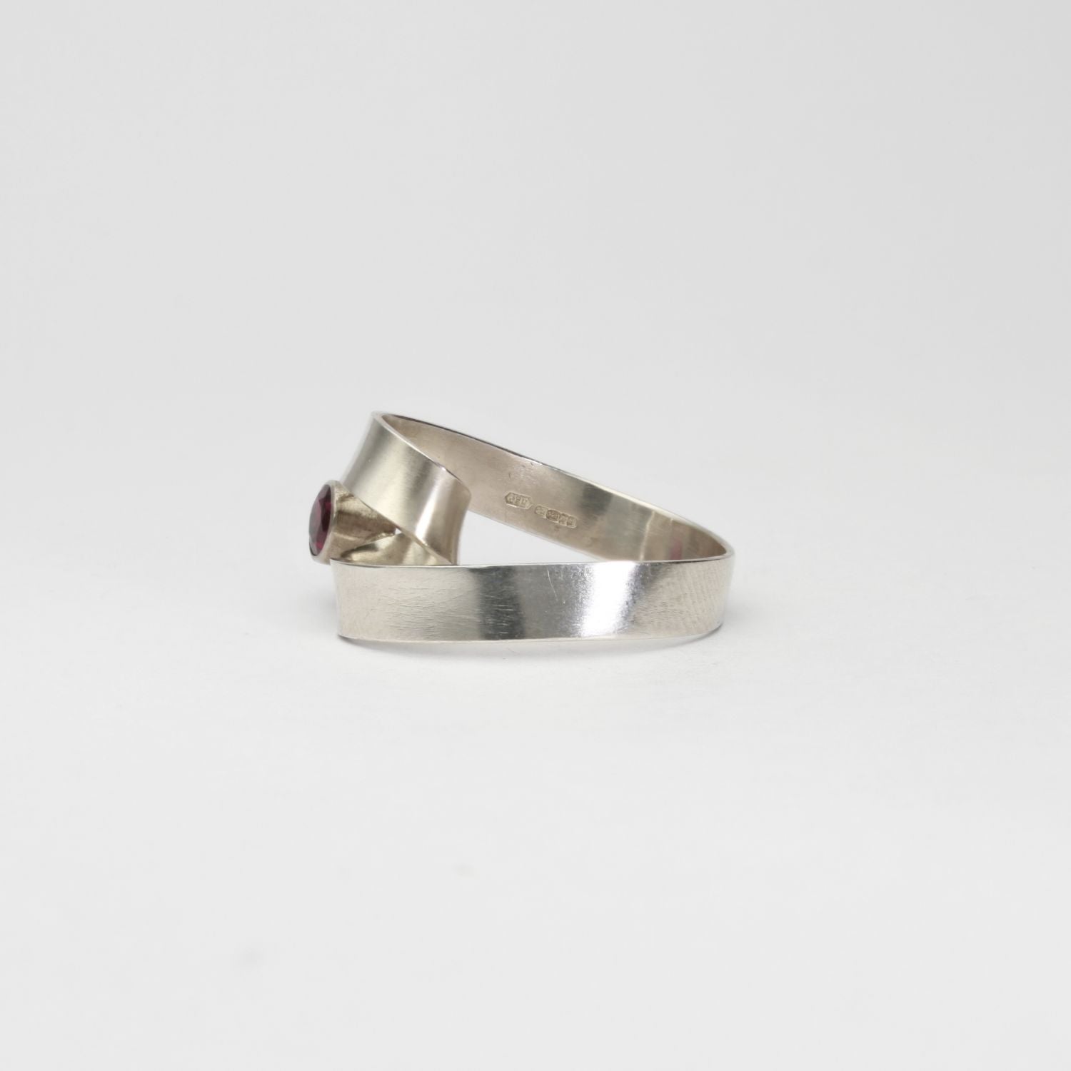 Ribbon loop ring in silver with garnet by Jodie Hook