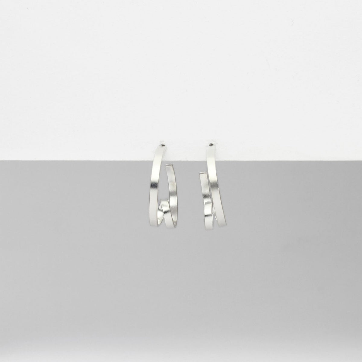 Mini ribbon loop silver hoop earrings by Jodie Hook