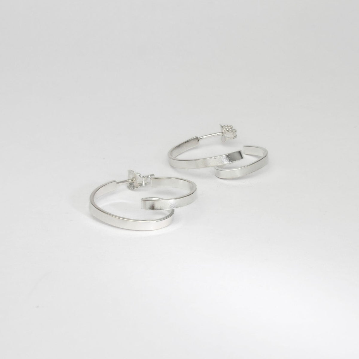 Mini ribbon loop silver hoop earrings by Jodie Hook
