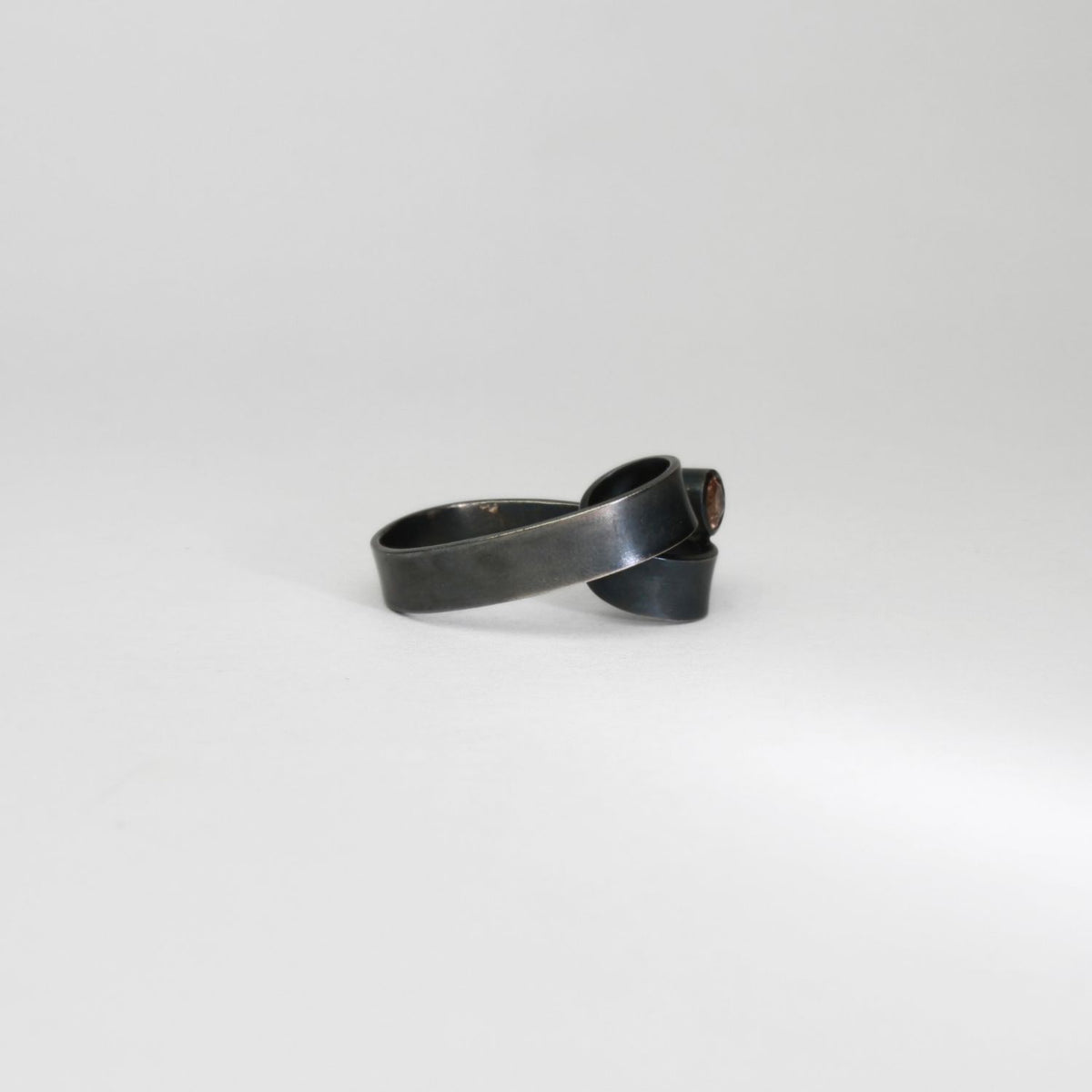 Ribbon solitaire loop black silver ring with imperial topaz by Jodie Hook