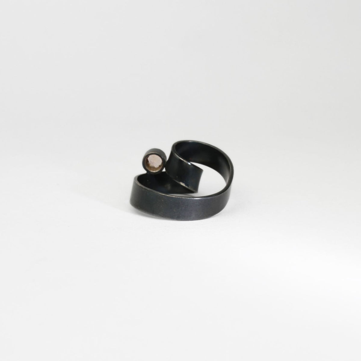 Ribbon solitaire loop black silver ring with imperial topaz by Jodie Hook