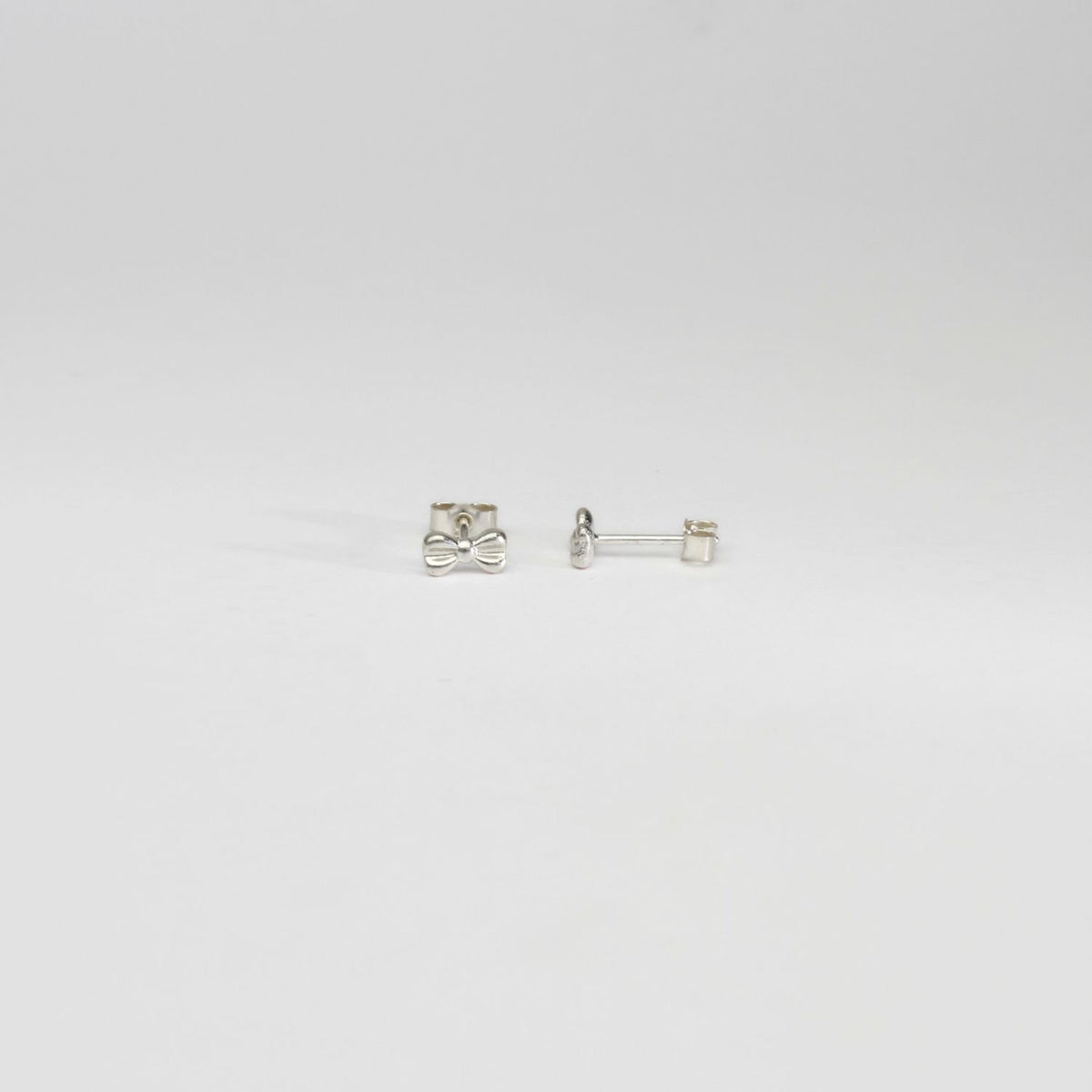 Bow silver earrings by Katy Tromans