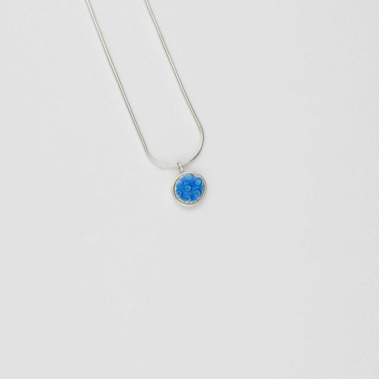 Small blue spot silver pendant by Kathryn Willis