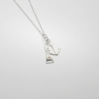 Anchor and lighthouse silver pendant by Kate Wimbush