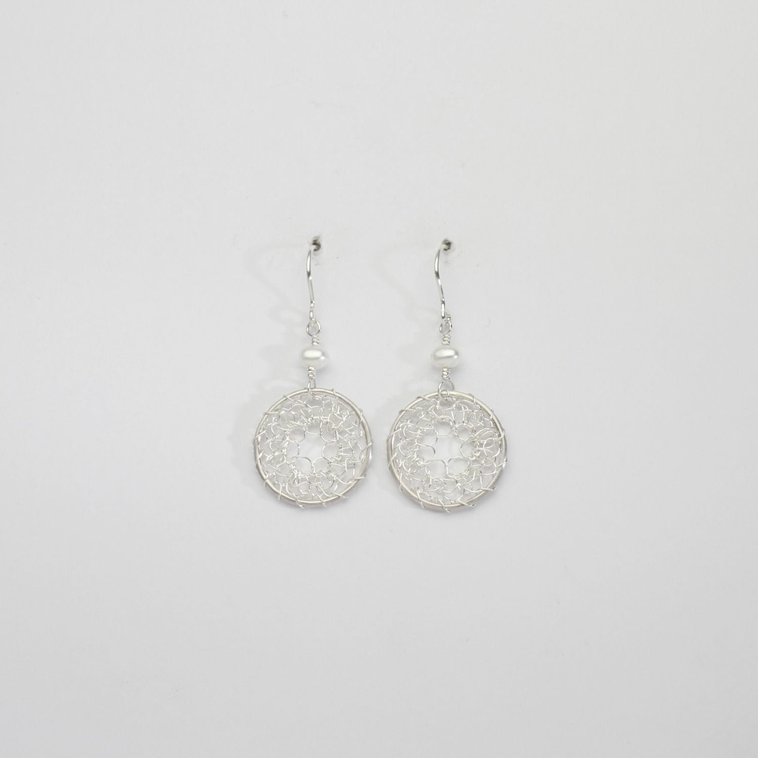 Lace circle & white pearl silver hook earrings by Natalie Vardey