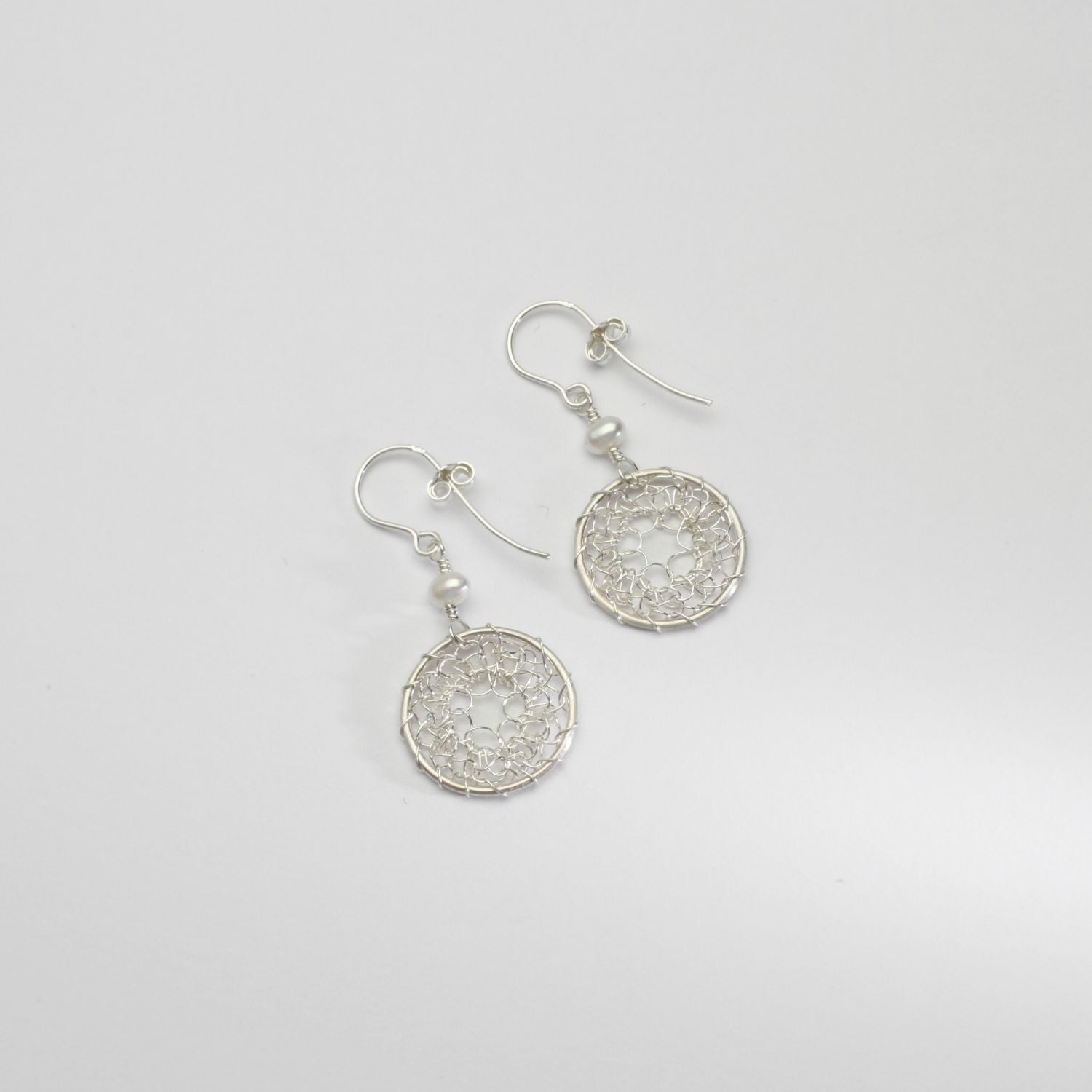 Lace circle & white pearl silver hook earrings by Natalie Vardey