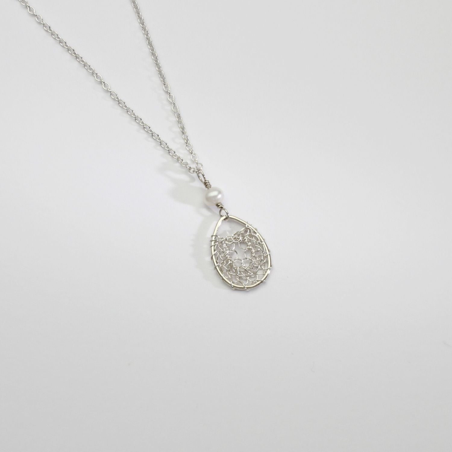 Silver oval lace and white pearl pendant by Natalie Vardey