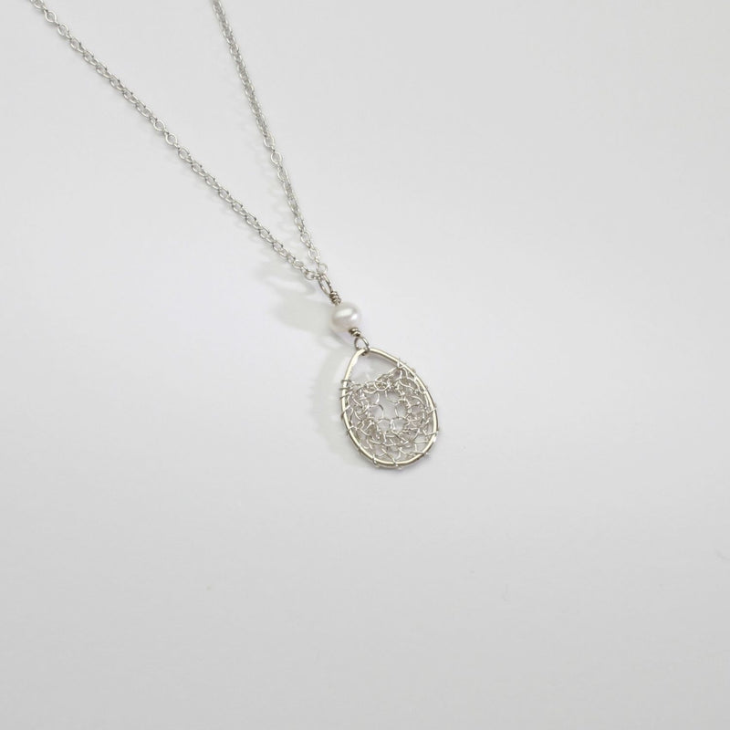Silver oval lace and white pearl pendant by Natalie Vardey