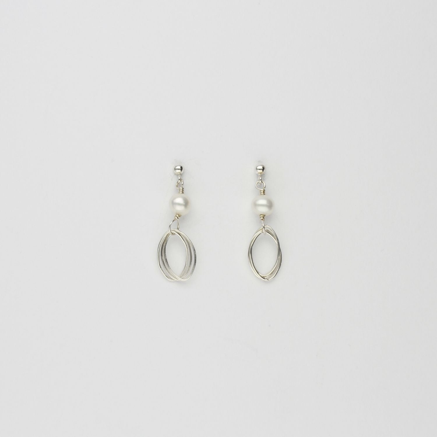 Triple loop & white pearl stud earrings by Natalie Vardey