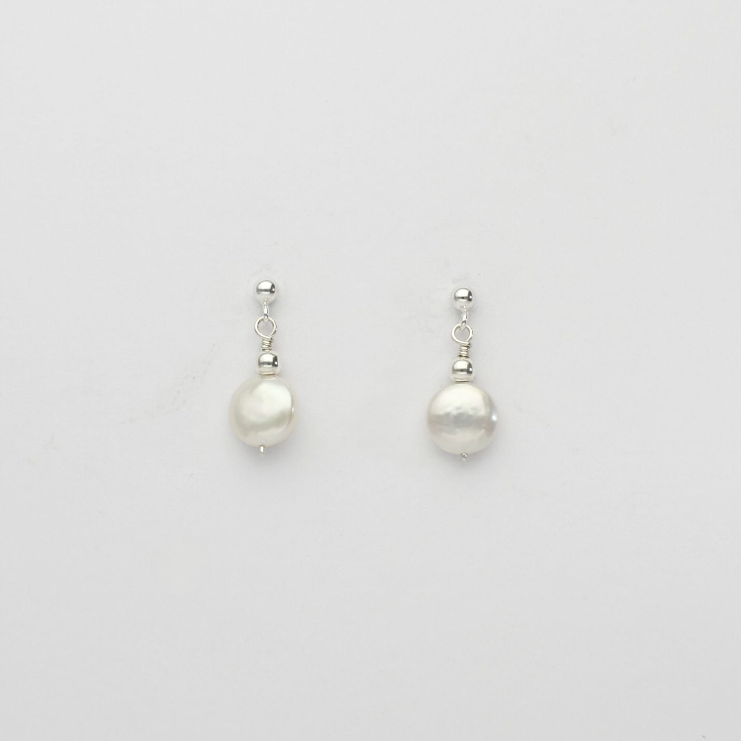 Small white coin pearl & bead stud earrings by Natalie Vardey