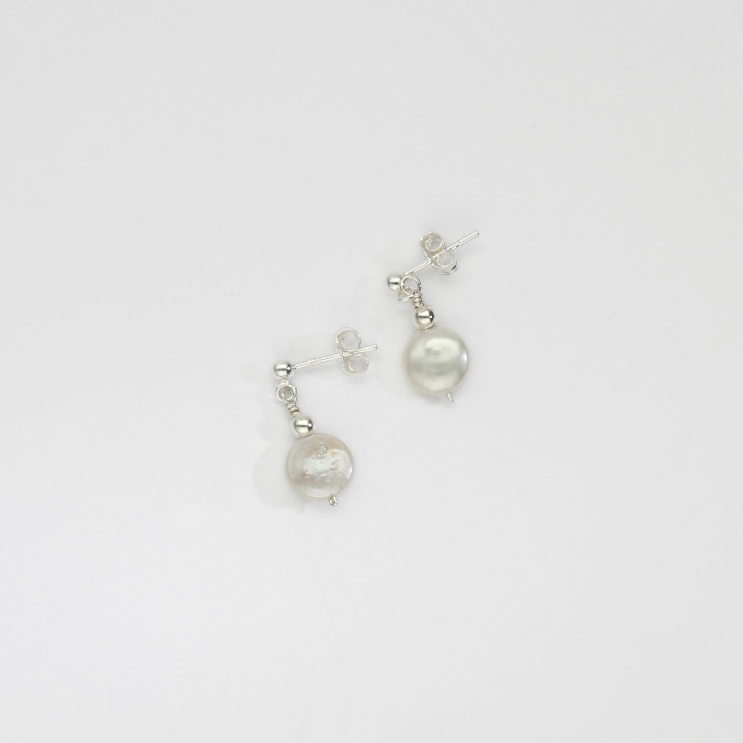 Small white coin pearl & bead stud earrings by Natalie Vardey