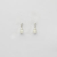 Small white & small white pearl stud earrings by Natalie Vardey