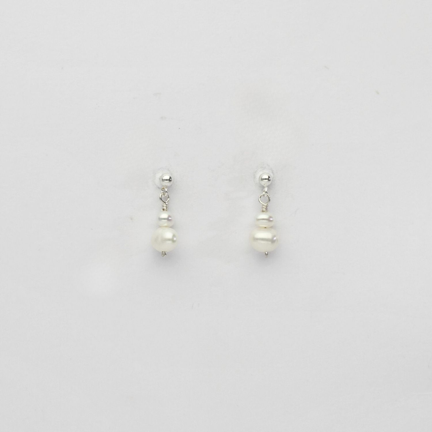 Small white & small white pearl stud earrings by Natalie Vardey