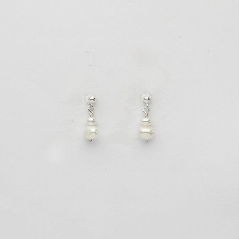 Small white & small white pearl stud earrings by Natalie Vardey