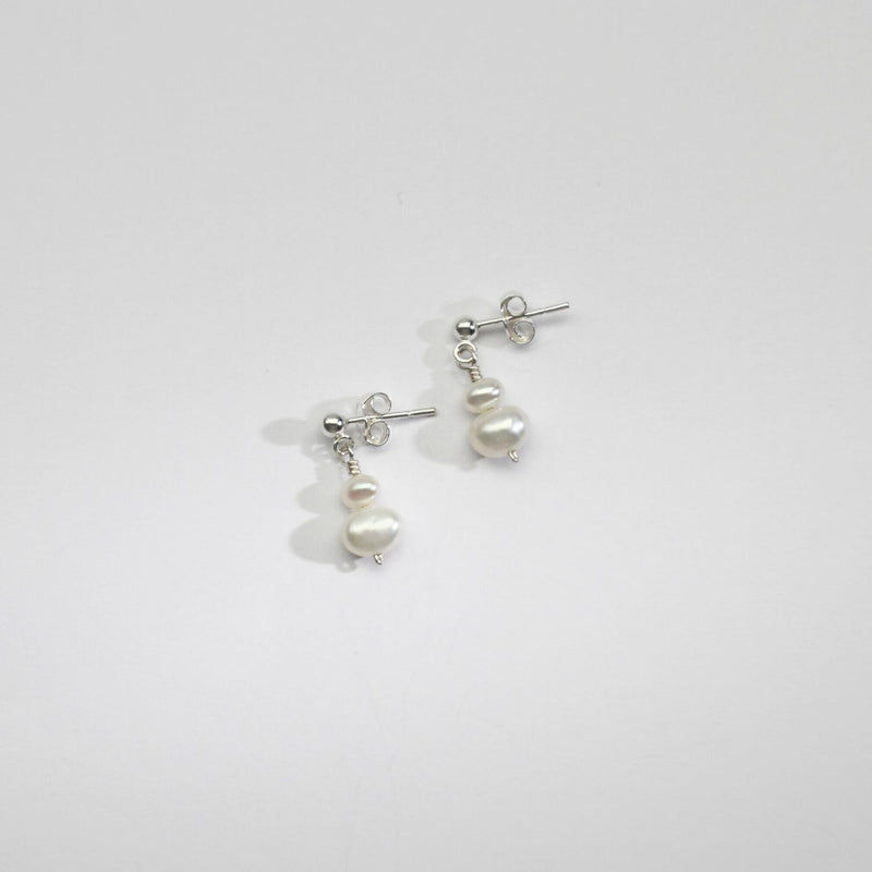 Small white & small white pearl stud earrings by Natalie Vardey