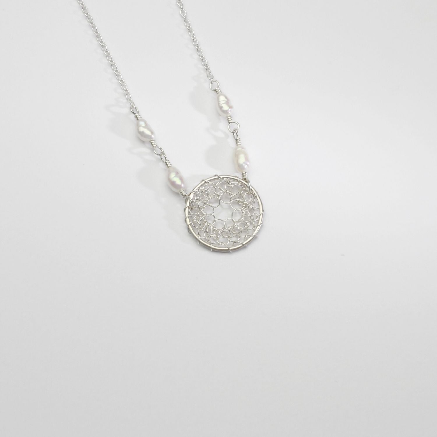 Lace circle & white pearl necklace by Natalie Vardey