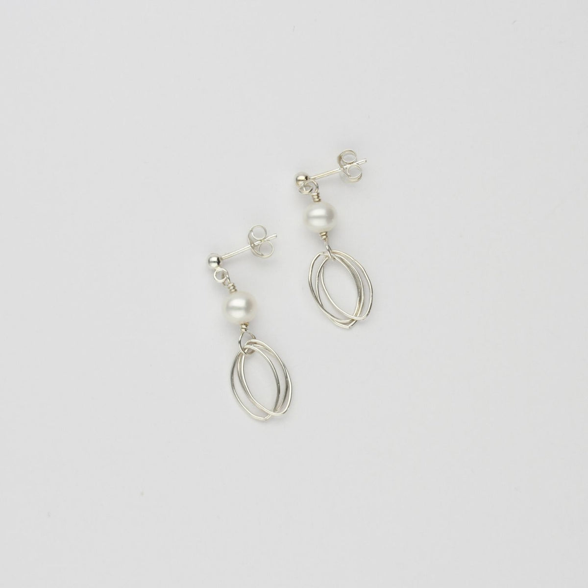 Triple loop & white pearl stud earrings by Natalie Vardey