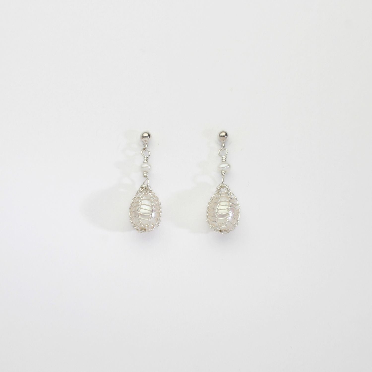 White pearl silver bound stud earrings by Natalie Vardey