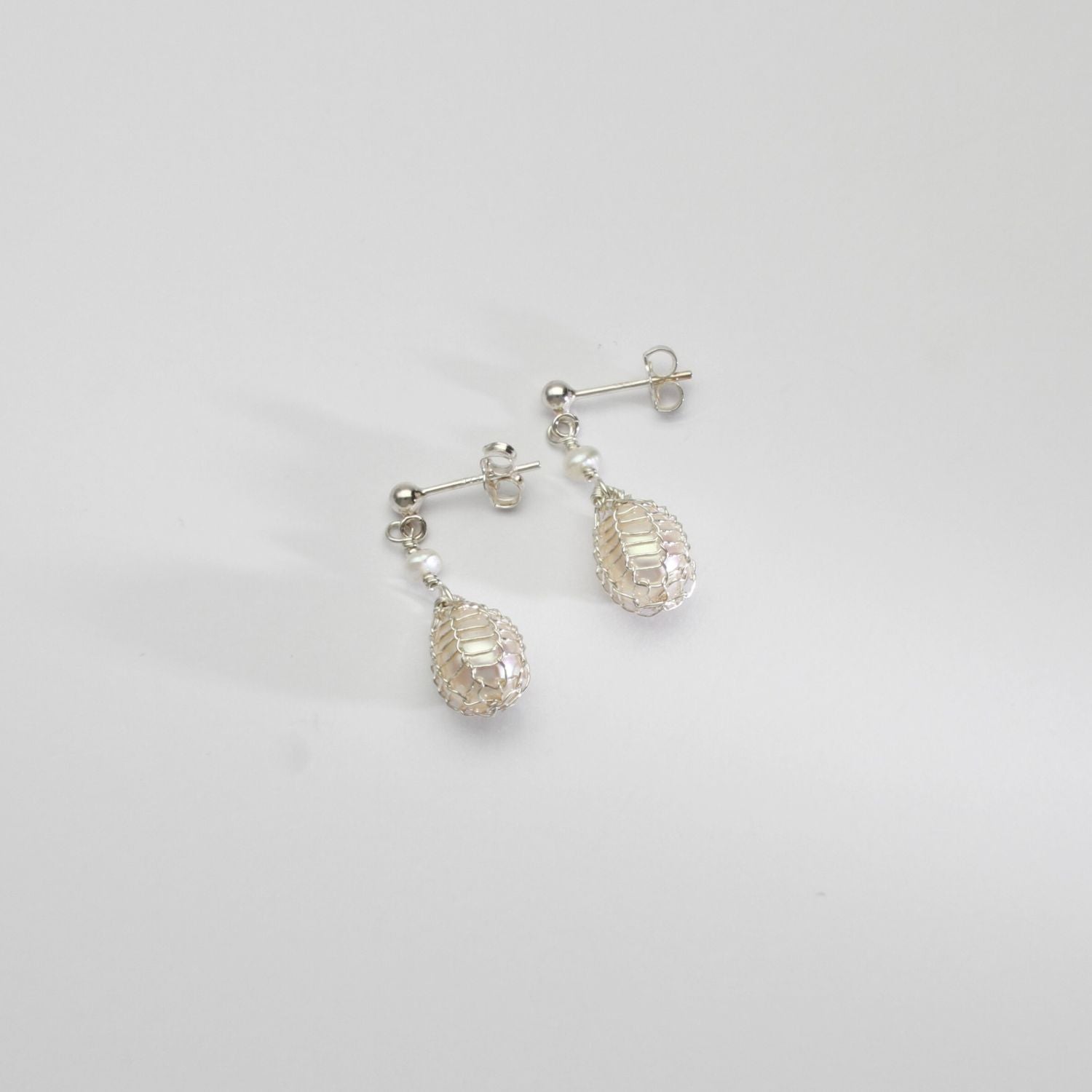 White pearl silver bound stud earrings by Natalie Vardey