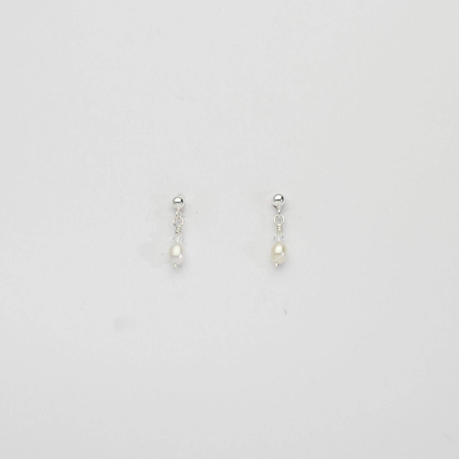 Small white rice & Swarovski crystal silver stud earrings by Natalie Vardey