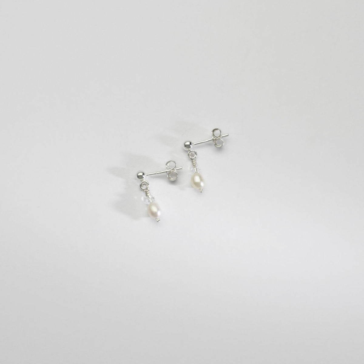 Small white rice & Swarovski crystal silver stud earrings by Natalie Vardey