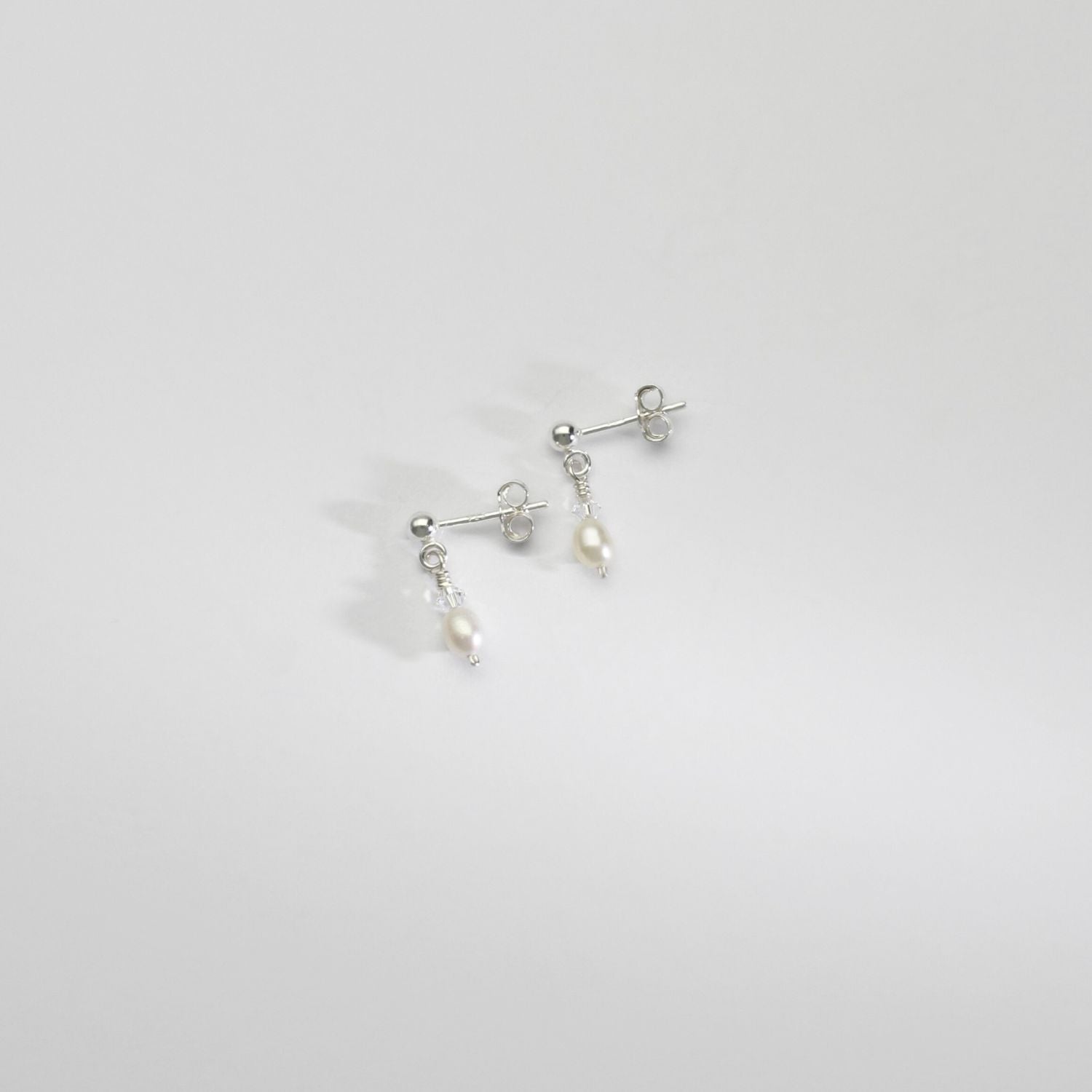 Small white rice & Swarovski crystal silver stud earrings by Natalie Vardey