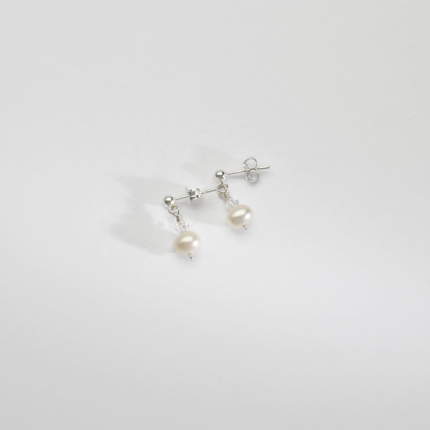 White squab & Swarovski crystal silver stud earrings by Natalie Vardey