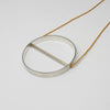 Spin silver necklace on yellow silk thread by Polished Grey