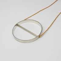 Spin silver necklace on yellow silk thread by Polished Grey