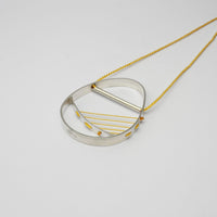 Hepworth silver necklace on yellow silk thread by Polished Grey