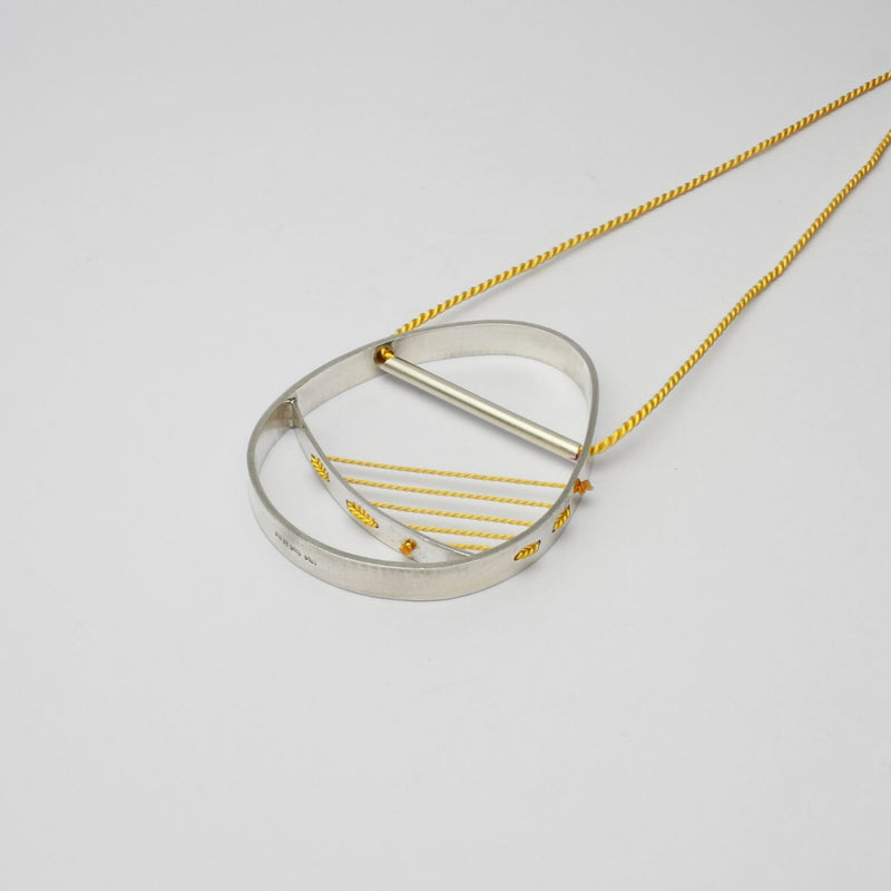 Hepworth silver necklace on yellow silk thread by Polished Grey