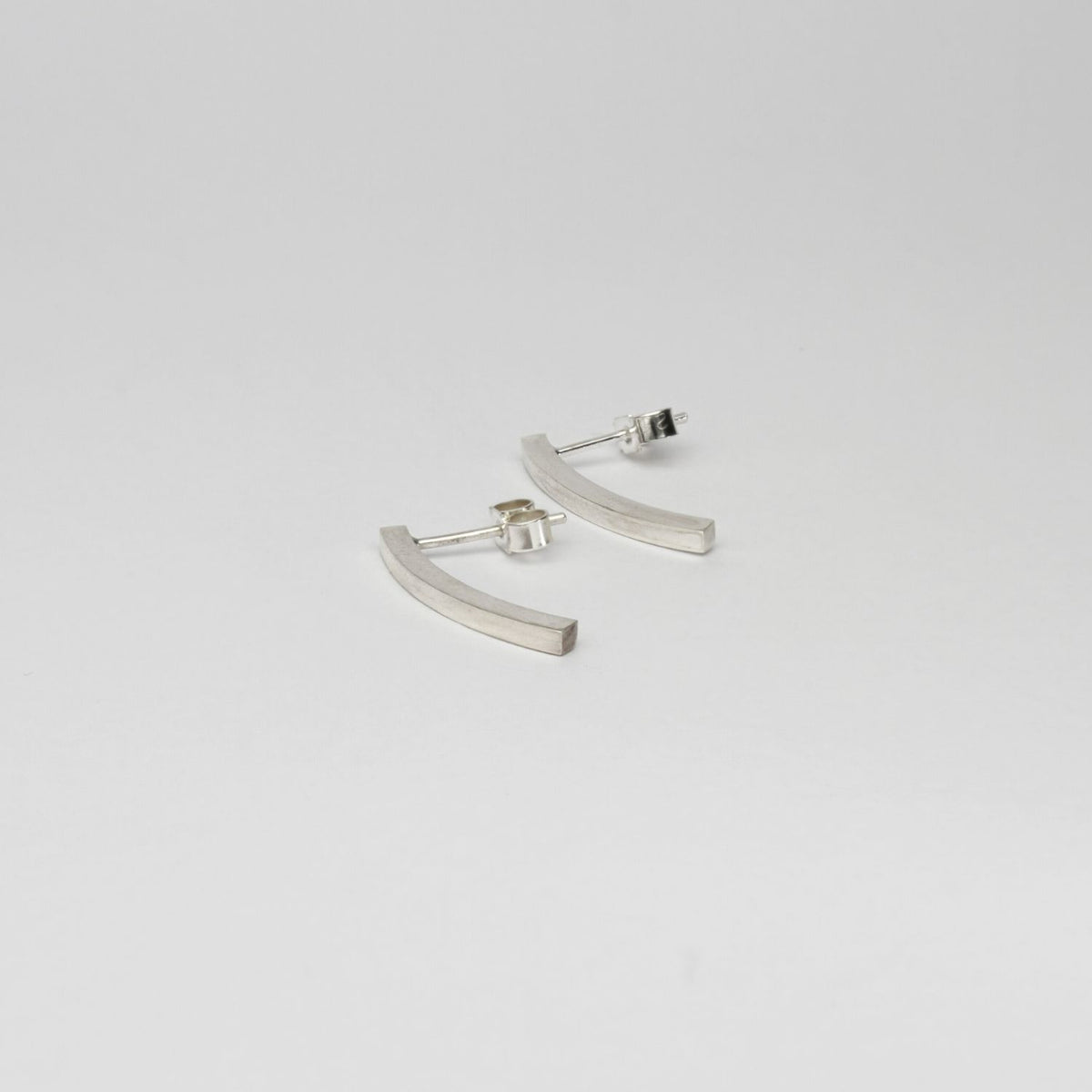 Large silver arc studs by Polished Grey