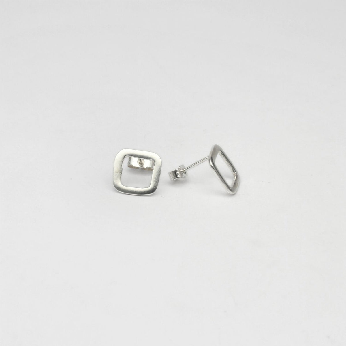 Small square silver studs by Polished Grey