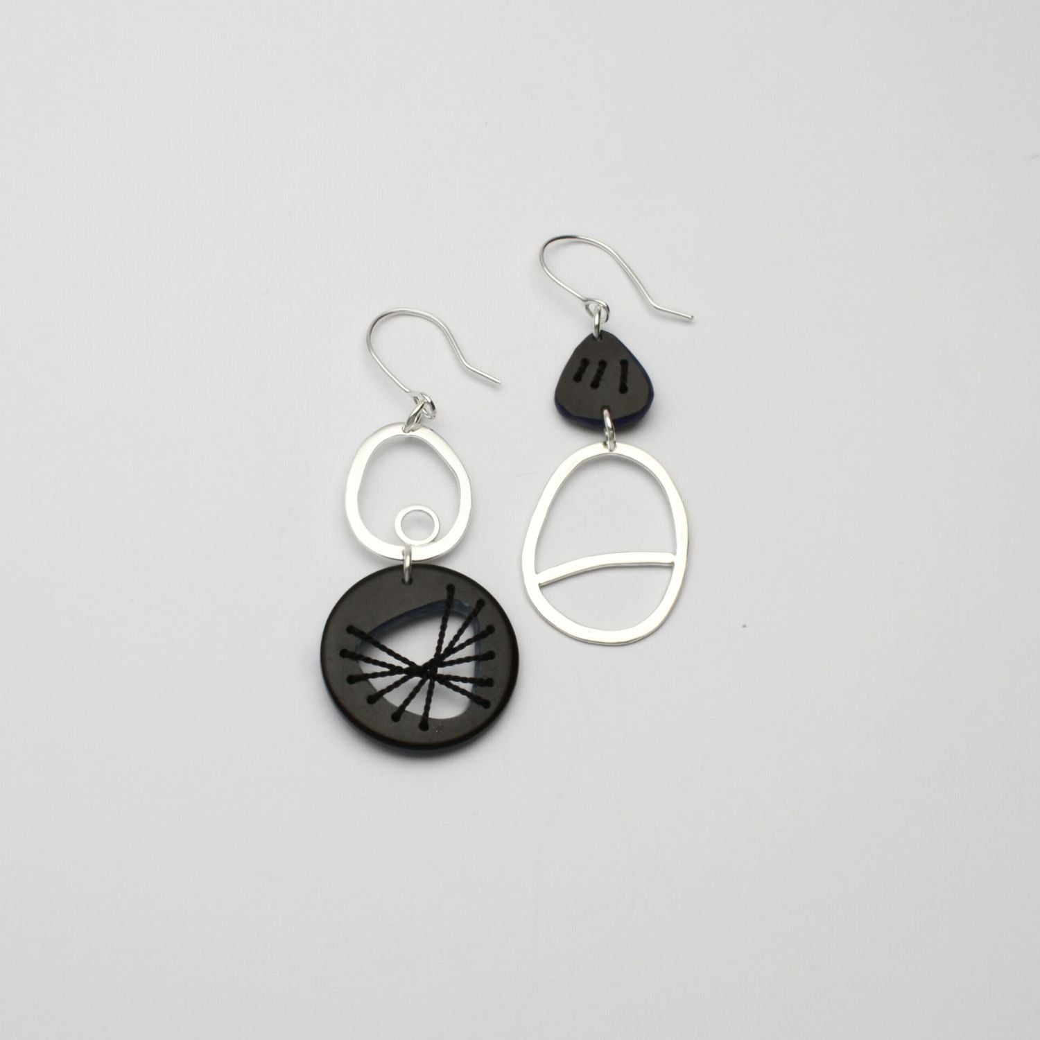 Black Tiddleywink stitched pebble silver earrings by Polished Grey