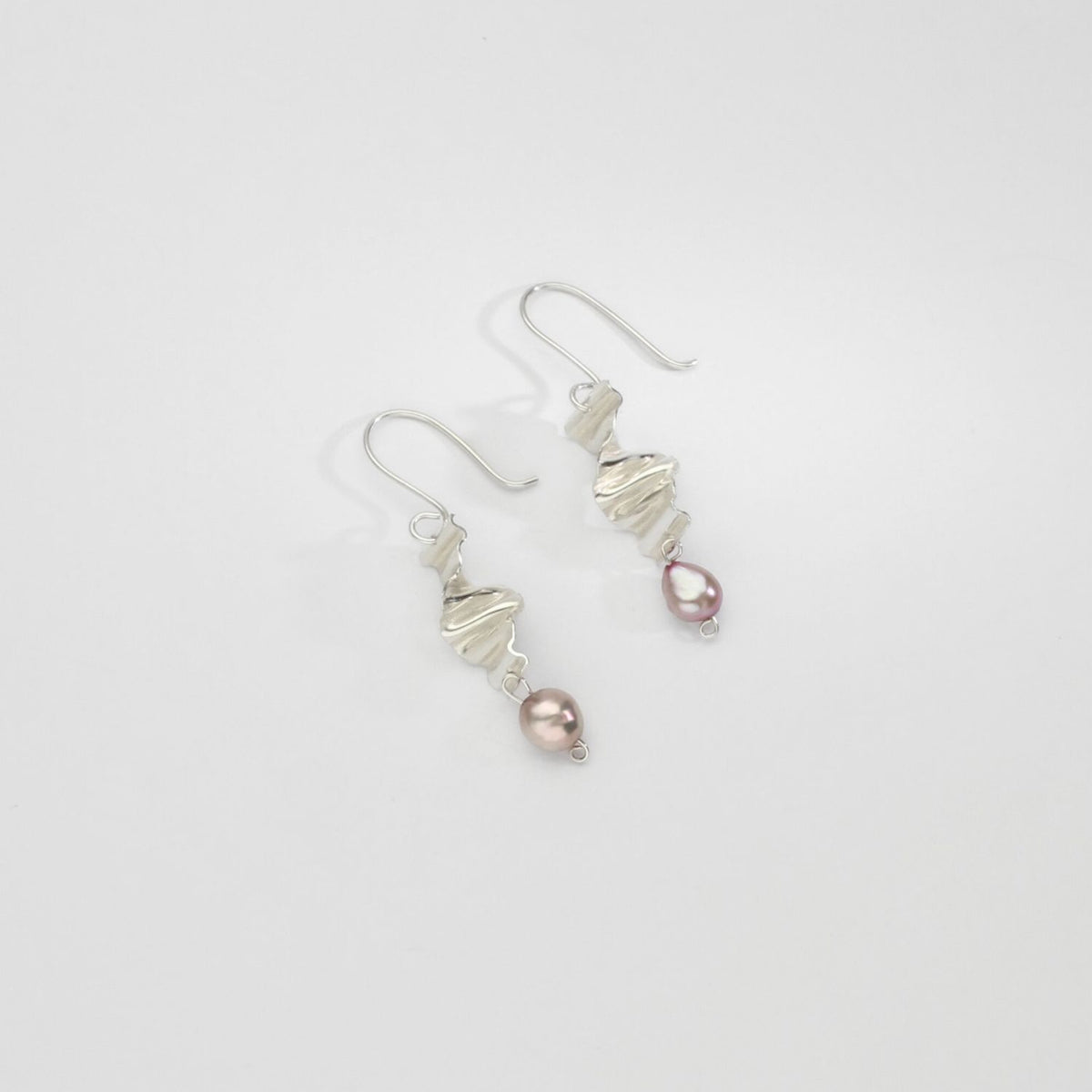 Silver long twizzle earrings with pink pearls by Suzie Horan