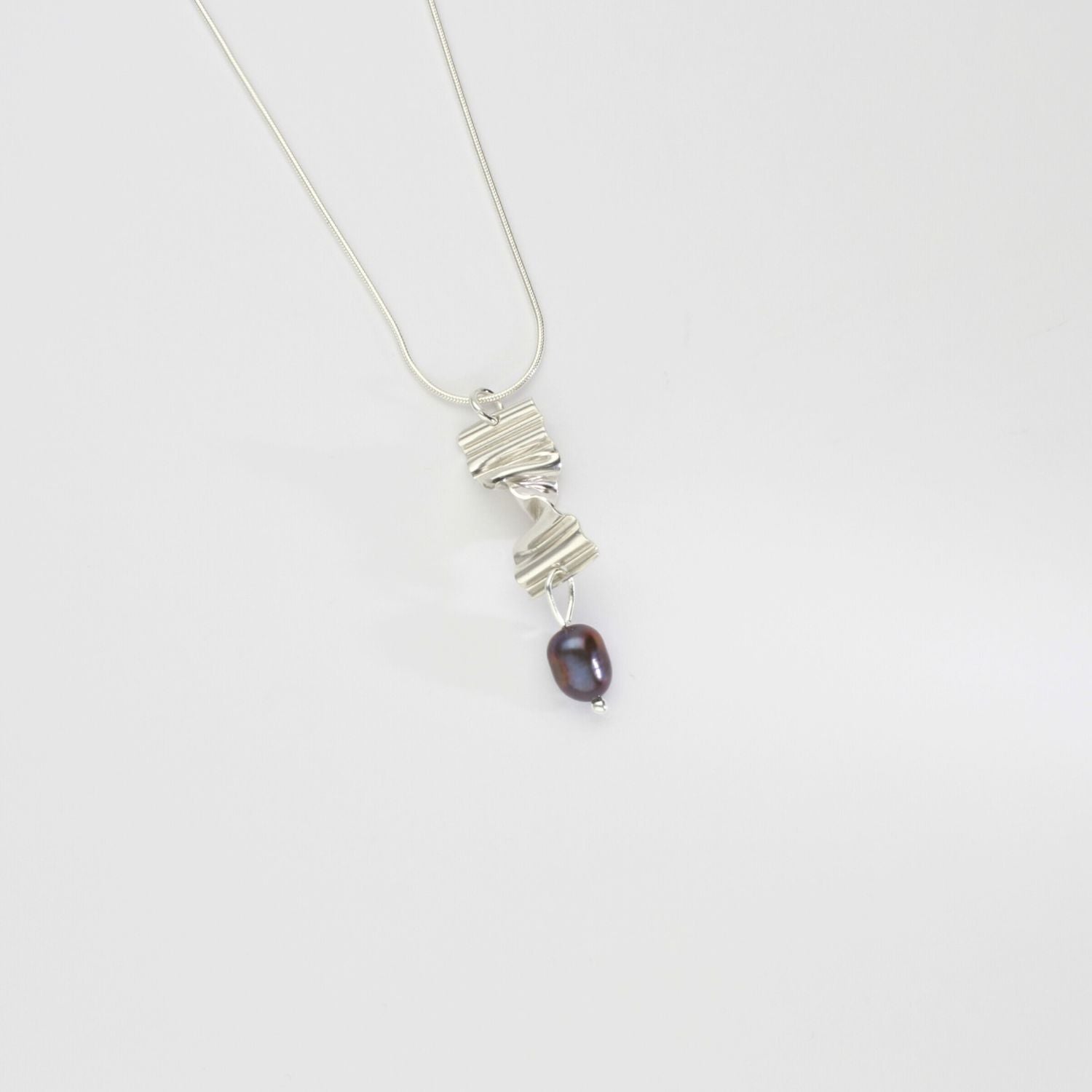 Long twizzle pendant with peacock pearl by Suzie Horan