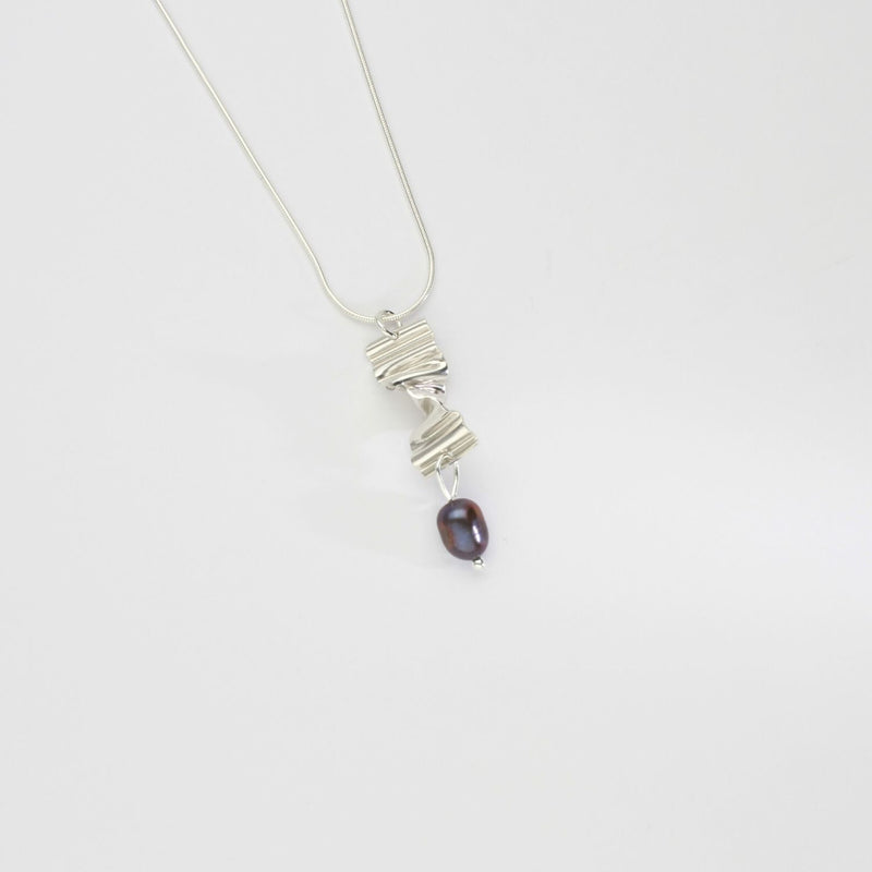 Long twizzle pendant with peacock pearl by Suzie Horan
