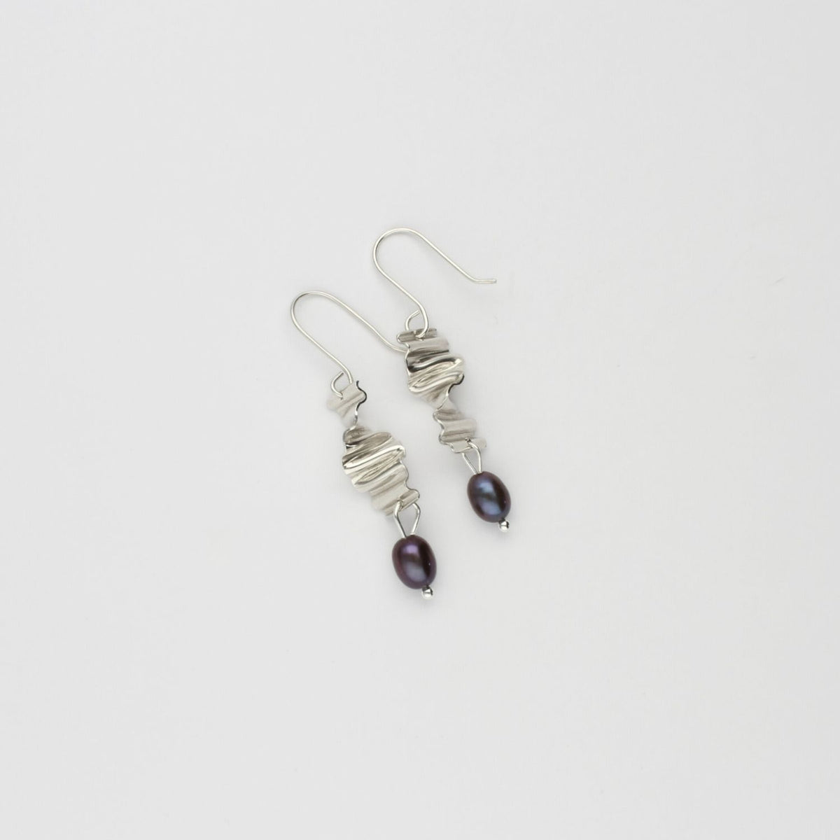 Long twizzle earrings with peacock pearls by Suzie Horan
