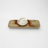Silver ammonite bowl on small driftwood with nails by Suzie Horan