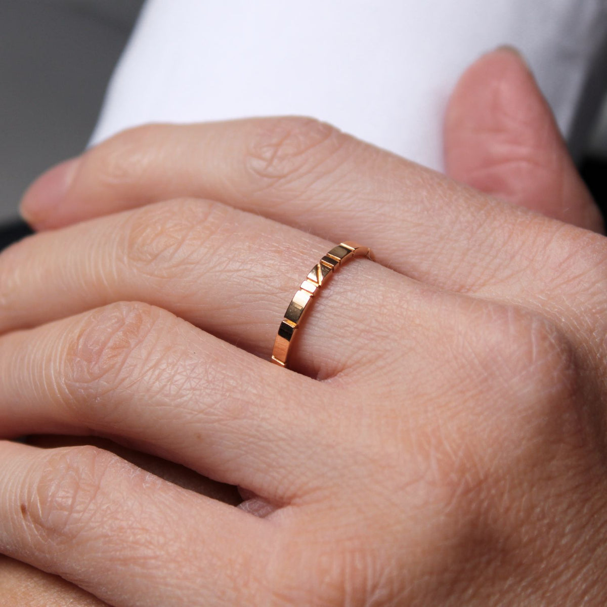 Welsh gold ring inspired by the strata of Welsh slate handcrafted and handmade in 18ct rose red gold. shown worn on model 