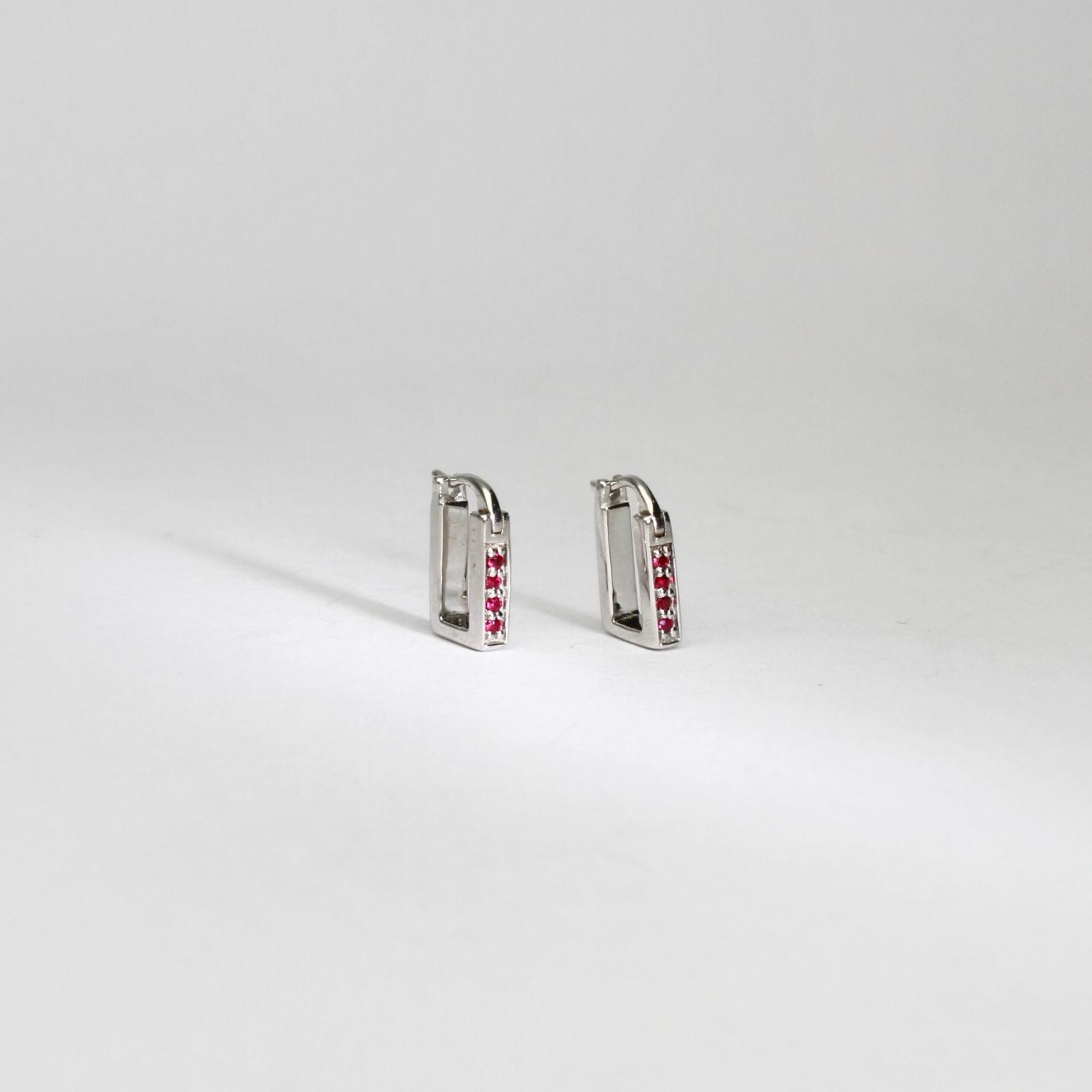 Rectangular silver hoop earrings with rubies by Yuki Mitsuyasu