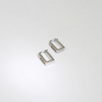 Rectangular silver hoop earrings with rubies by Yuki Mitsuyasu