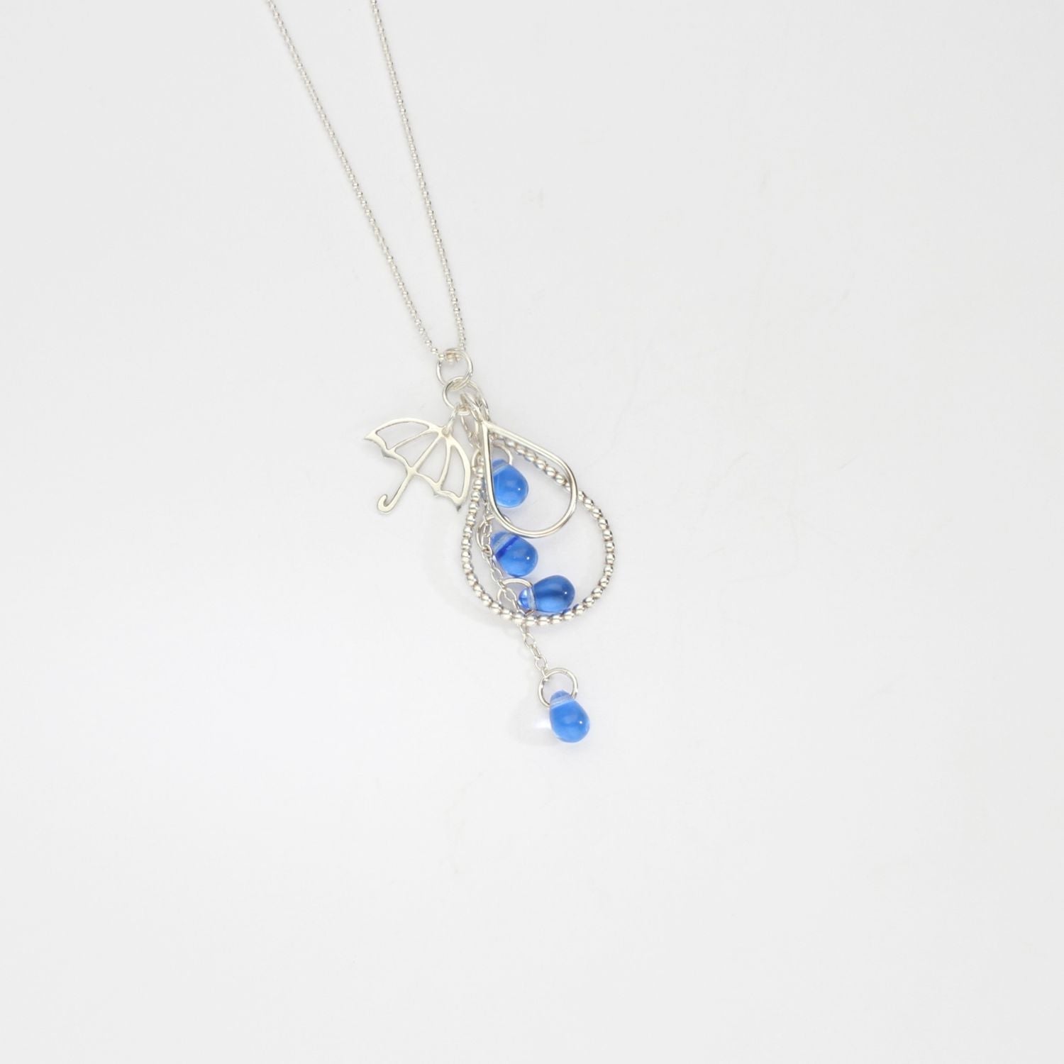 Brolly & raindrop silver pendant with blue glass by Kate Wimbush