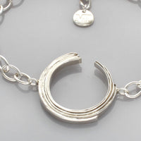 Close-up of the Brushstroke bracelet's charm, inspired by a single artist's gesture — Breichled Arian