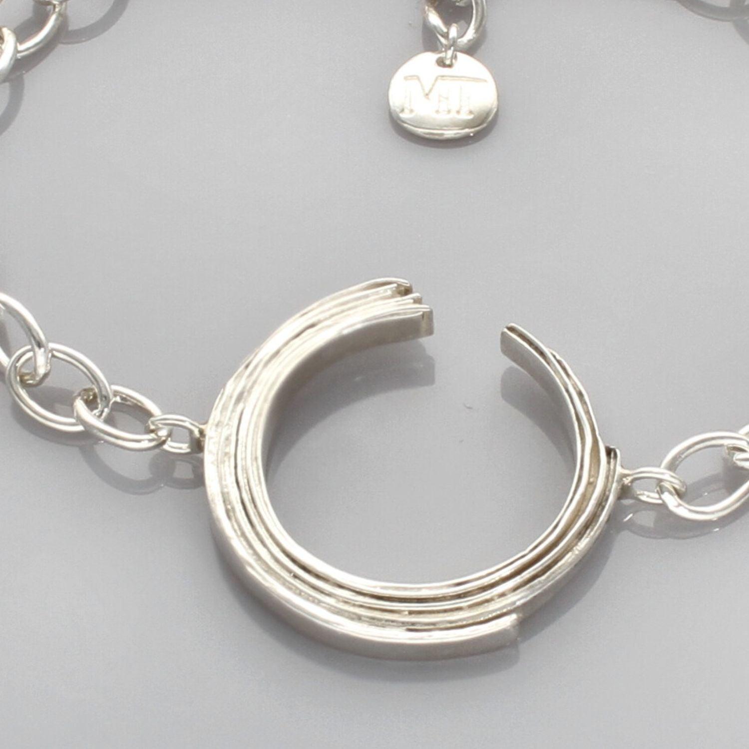 Close-up of the Brushstroke bracelet's charm, inspired by a single artist's gesture — Breichled Arian