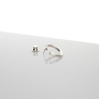 Close-up of the Brushstroke lapel pin's fluid line, echoing an artist's gesture