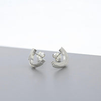 Close-up of the Brushstroke earring's fluid line, echoing an artist's gesture — Clustdlysau Arian